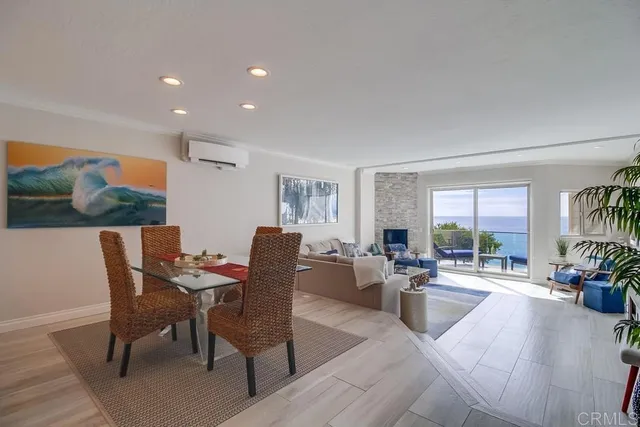 a living room with fireplace furniture and a large window