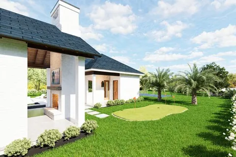 a view of a house with a big yard potted plants and large tree