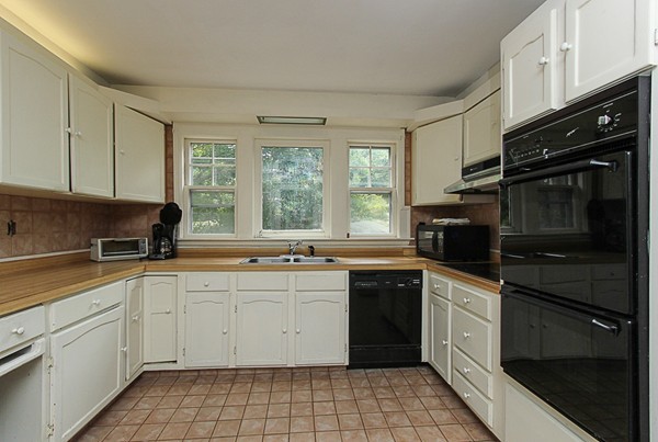 31 Decatur Street Gloucester, MA 01930 - Photo 6 of 17 a kitchen with a sink stove and cabinets