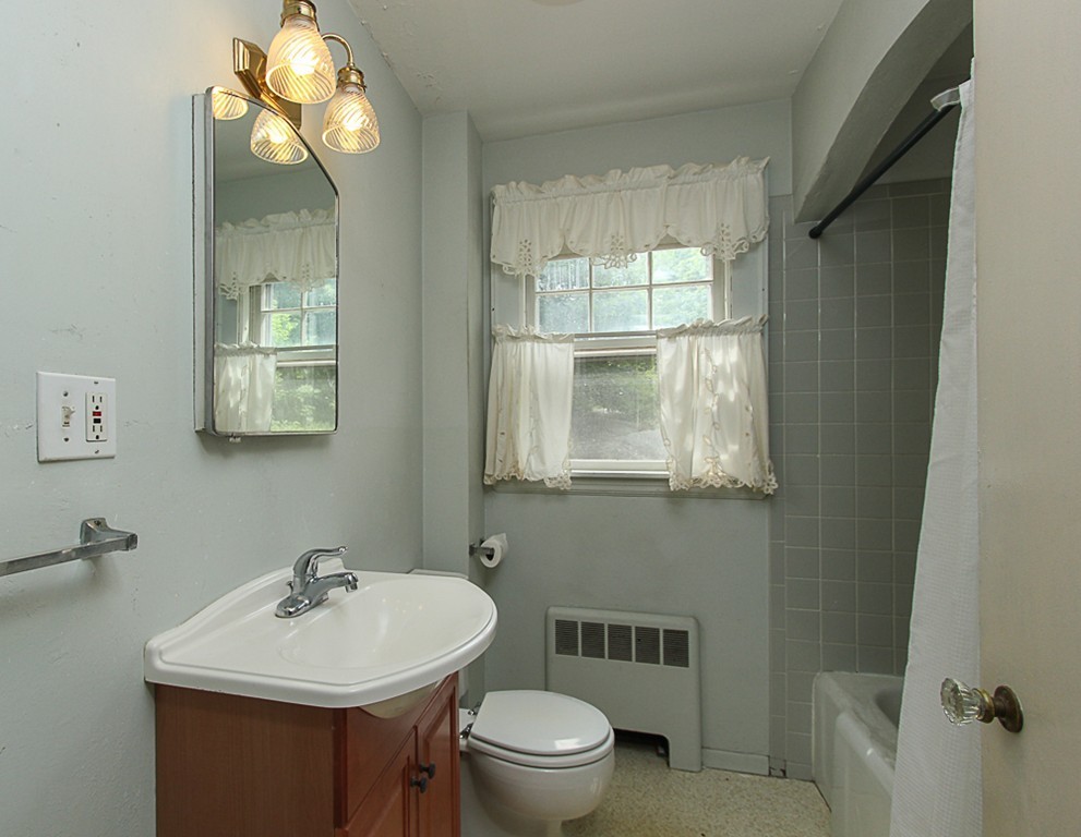 31 Decatur Street Gloucester, MA 01930 - Photo 7 of 17 a bathroom with a toilet sink and mirror