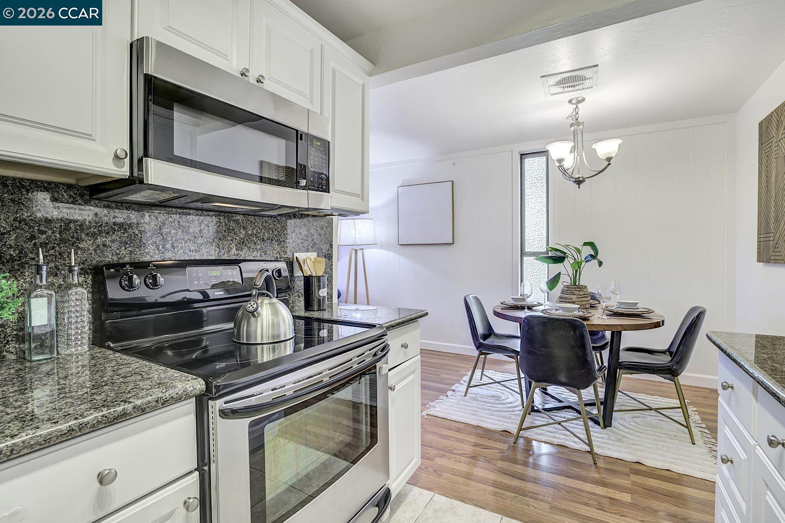 2650 Jones Road, Unit 14 Walnut Creek, CA 94597 - Photo 11 of 44 a kitchen with a stove a microwave and cabinets