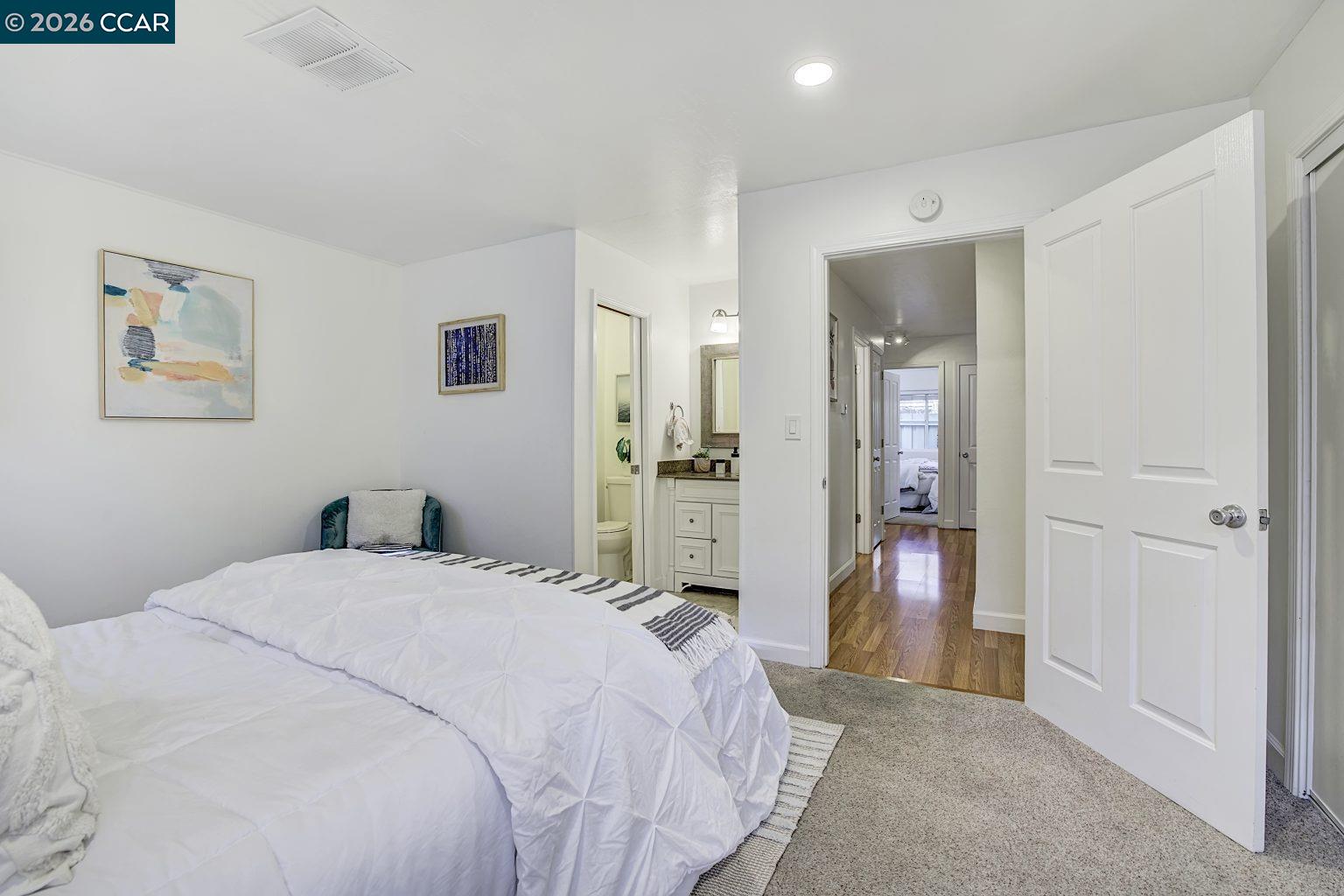 2650 Jones Road, Unit 14 Walnut Creek, CA 94597 - Photo 20 of 44 a bedroom with a bed and a chandelier