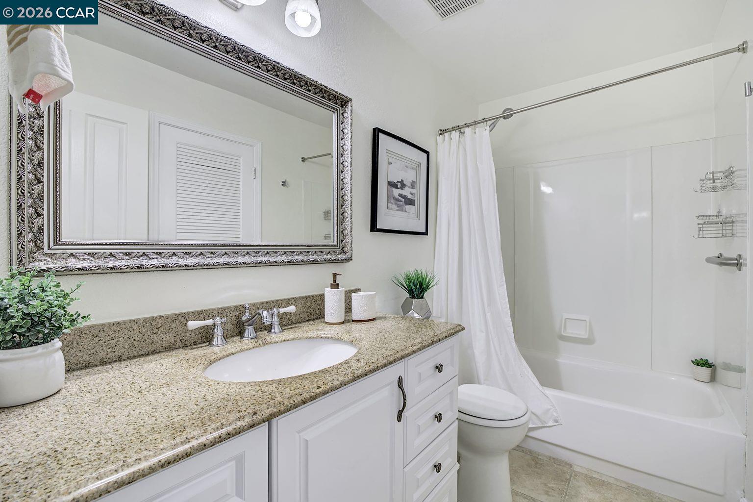 2650 Jones Road, Unit 14 Walnut Creek, CA 94597 - Photo 26 of 44 a bathroom with a granite countertop sink a toilet and shower