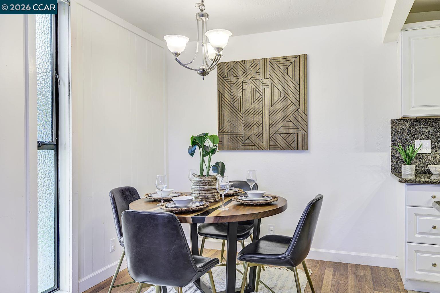 2650 Jones Road, Unit 14 Walnut Creek, CA 94597 - Photo 10 of 44 a view of a dining room with furniture and chandelier