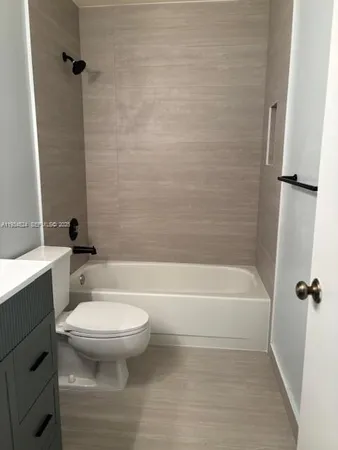 a bathroom with a toilet and a bath tub