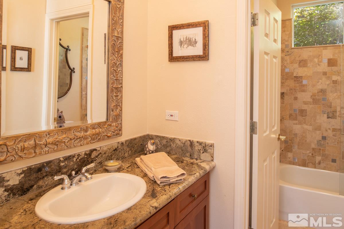 1673 Aspen Creek Road Reno, NV 89519 - Photo 21 of 40 a bathroom with a sink and a mirror
