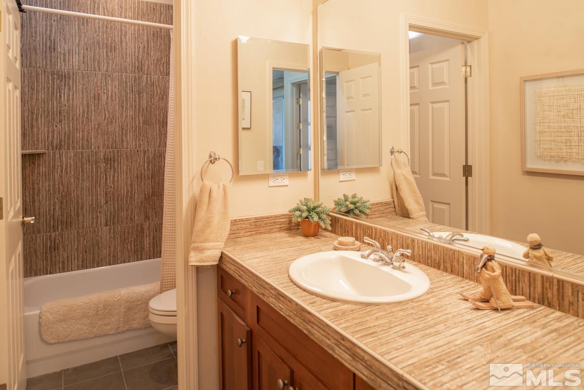 1673 Aspen Creek Road Reno, NV 89519 - Photo 25 of 40 a bathroom with a sink double vanity and a bathtub