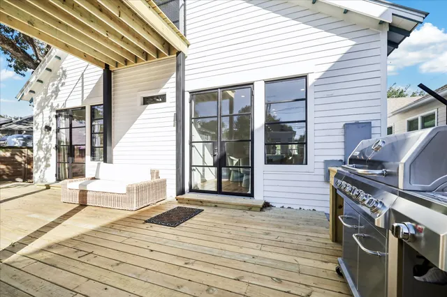 a view of a deck with open kitchen