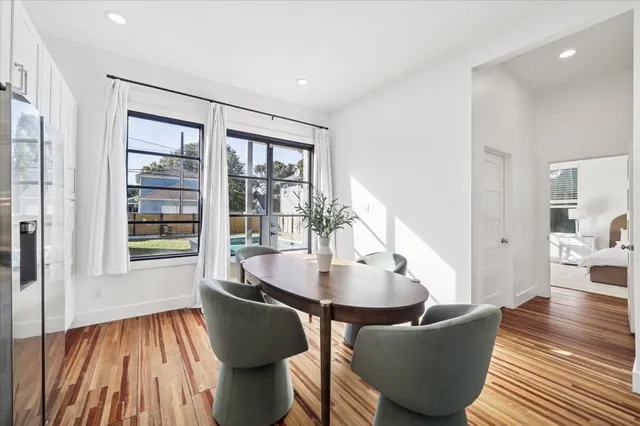 a dining room with furniture and wooden floor