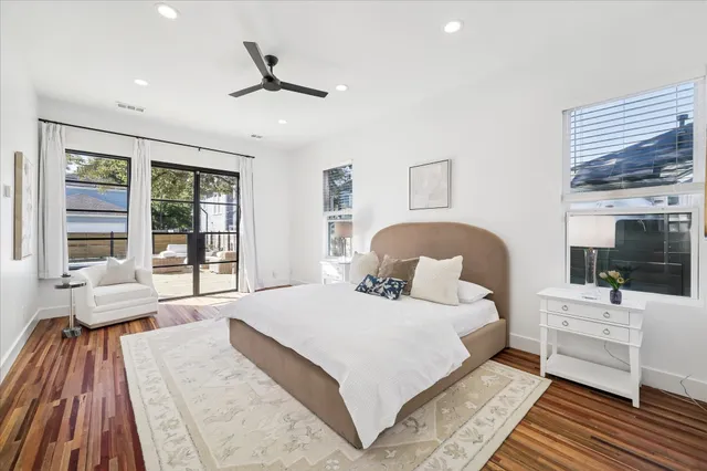 a bedroom with a large bed and a chandelier