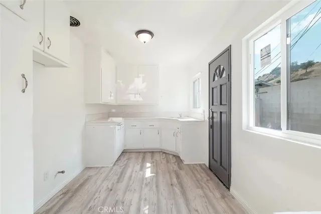 a view of a kitchen cabinets a sink and a window