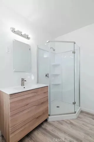 a view of a kitchen with sink hardwood floor and a stove top oven