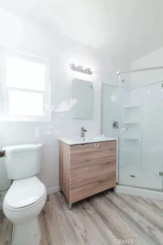 a bathroom with a sink a mirror and a shower