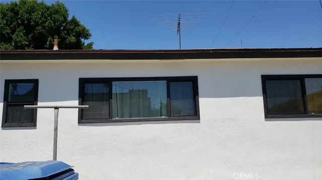 an aerial view of residential houses with city view