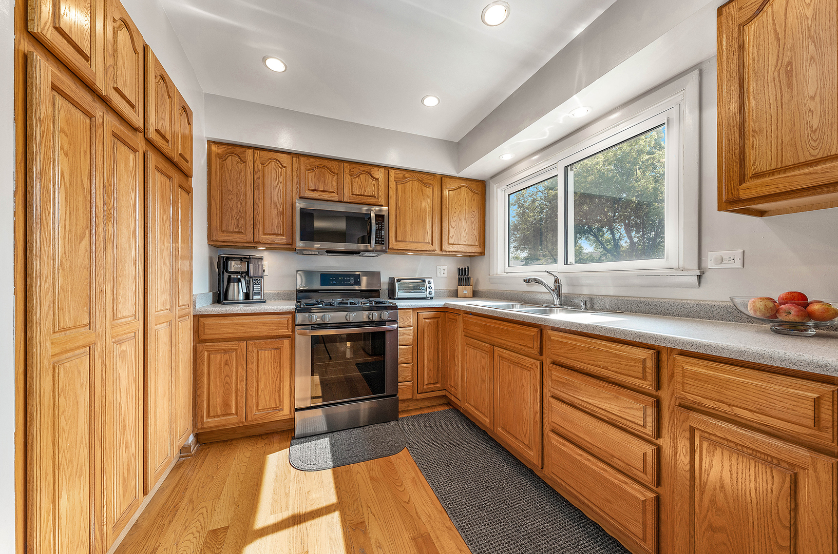 349 North Pinecrest Road Bolingbrook, IL 60440 - Photo 5 of 25 a kitchen with stainless steel appliances granite countertop a stove a sink and a microwave