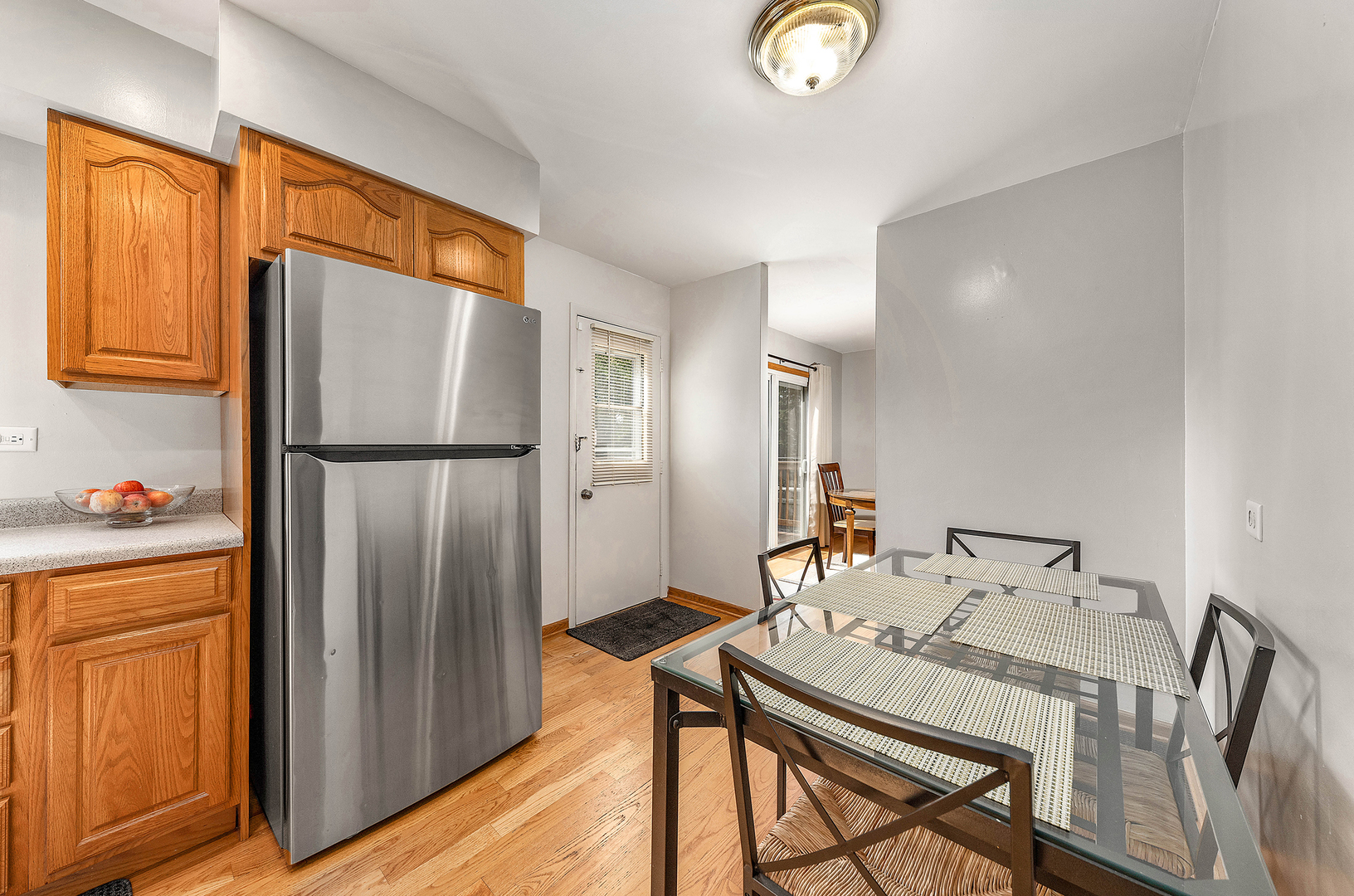 349 North Pinecrest Road Bolingbrook, IL 60440 - Photo 6 of 25 a kitchen with stainless steel appliances granite countertop a refrigerator a sink and a stove with wooden floor