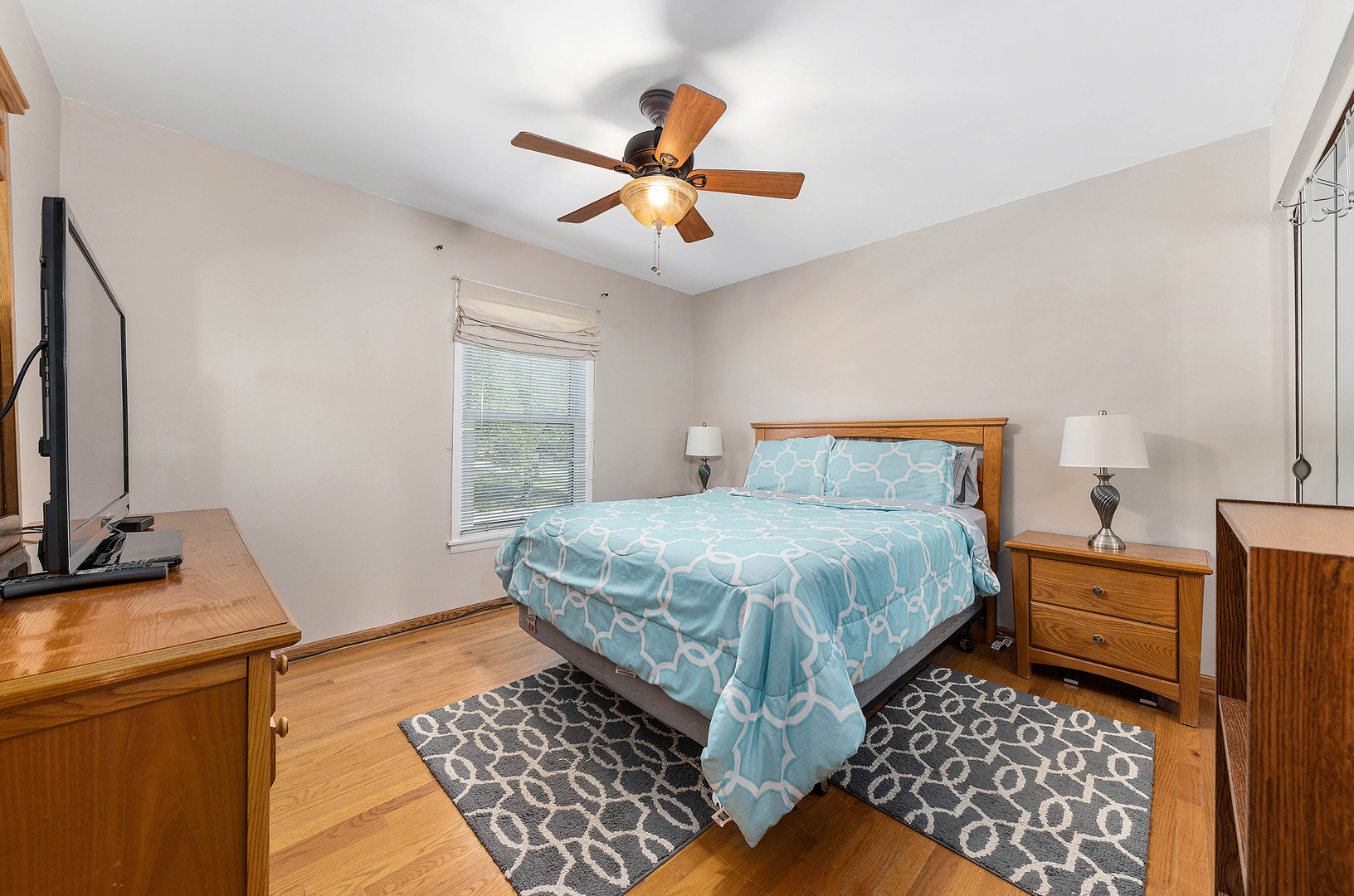 349 North Pinecrest Road Bolingbrook, IL 60440 - Photo 7 of 25 a bedroom with a bed and wooden floor