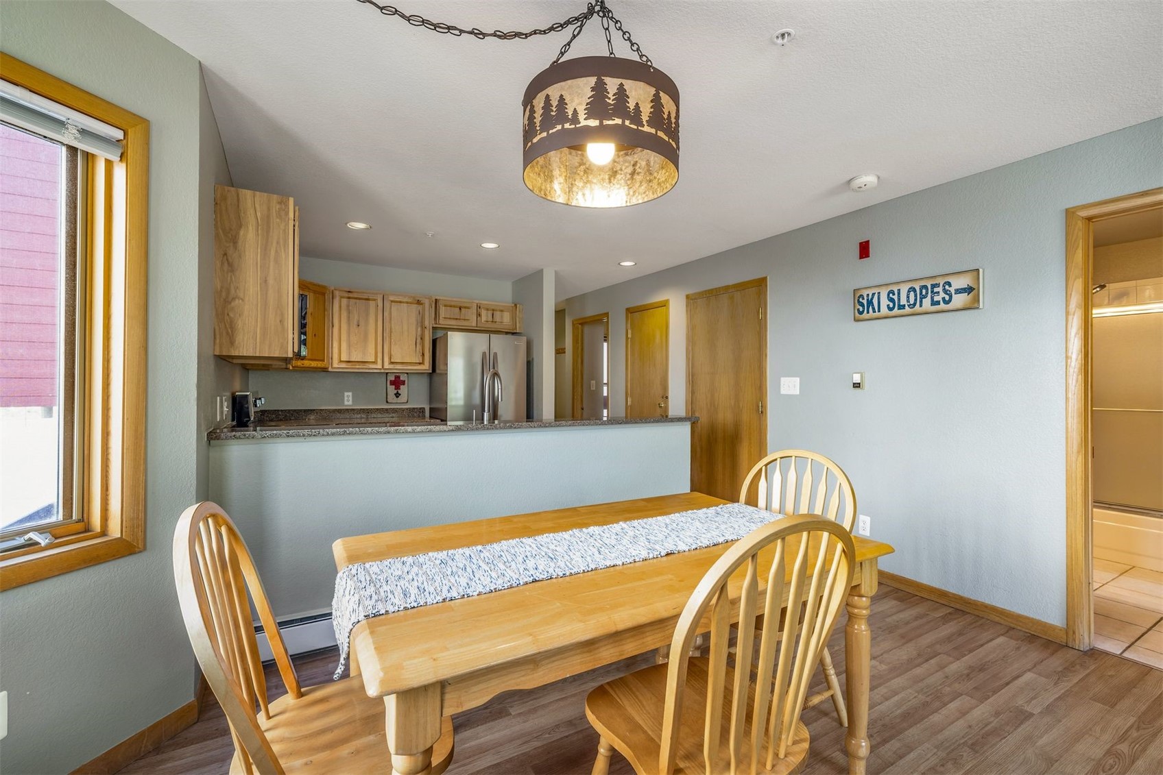 60 Oro Grande Road, Unit 204 Keystone, CO 80435 - Photo 14 of 50 a view of a dining room with furniture and wooden floor