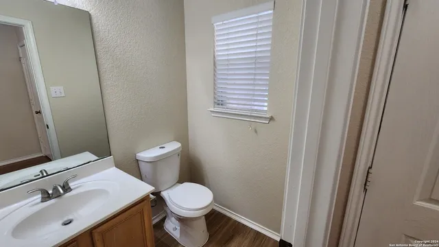 a bathroom with a sink a toilet and a mirror