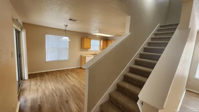 a view of entryway with wooden floor and stairs