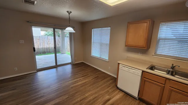 a kitchen with wooden floors and sink