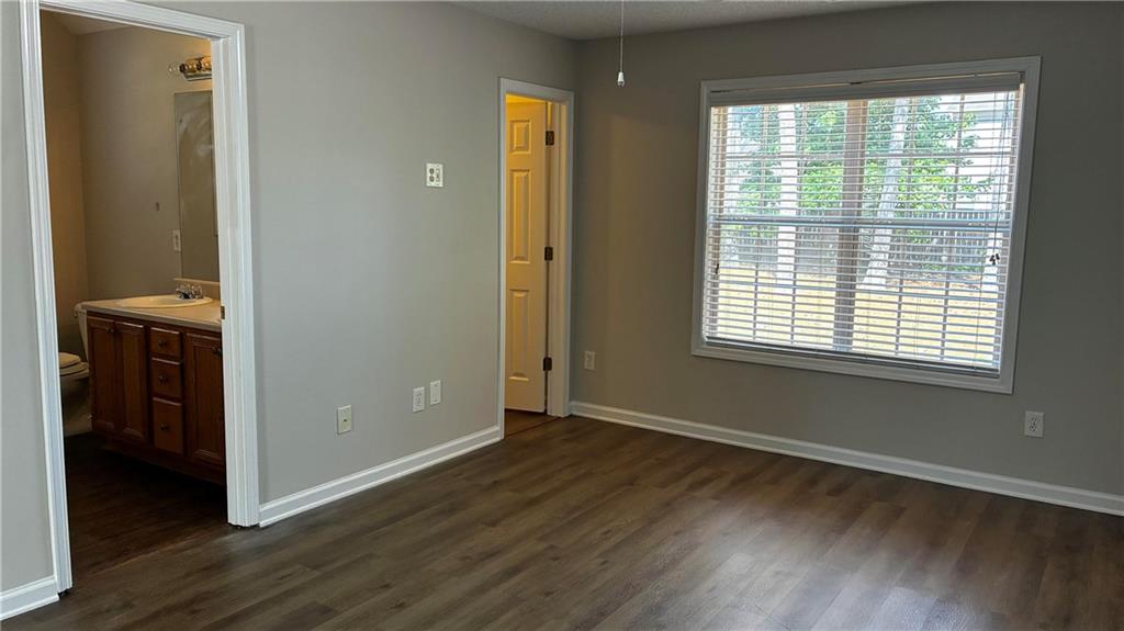 337 Madison Avenue Hampton, GA 30228 - Photo 18 of 32 a view of an empty room with wooden floor and a window