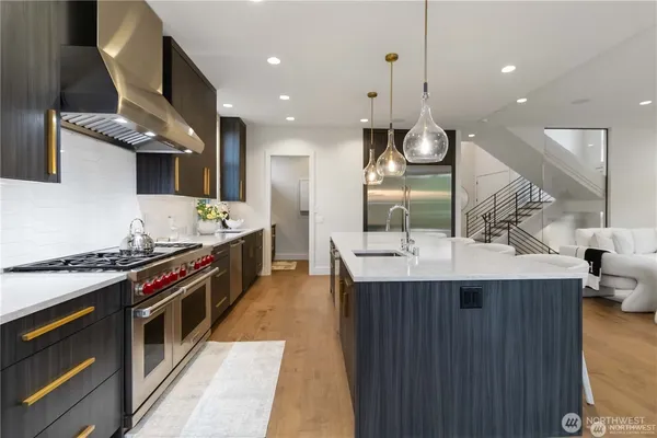 a kitchen with stainless steel appliances a sink and a stove