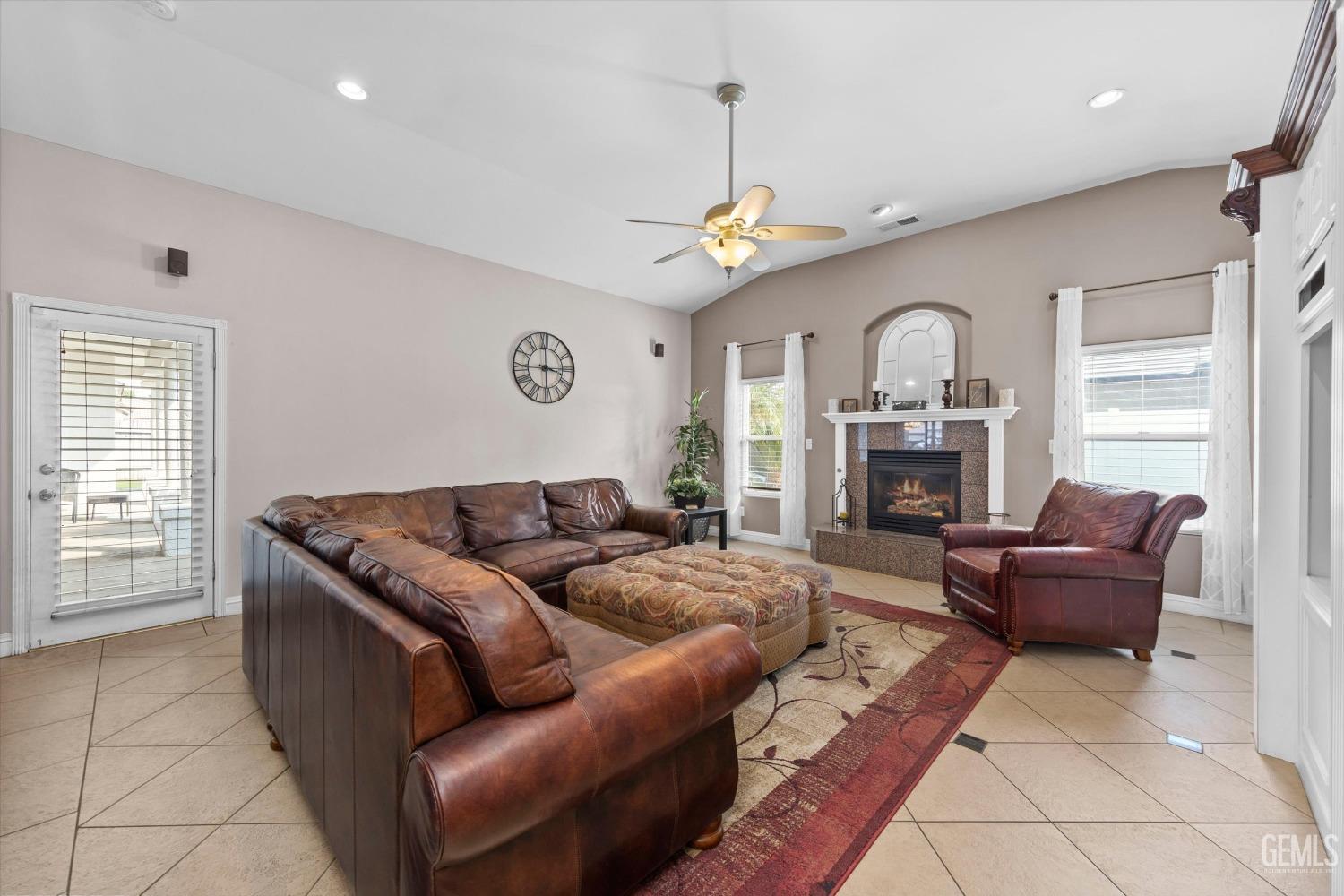 Undisclosed Address Bakersfield, CA 93314 - Photo 11 of 34 a living room with furniture a fireplace and a flat screen tv