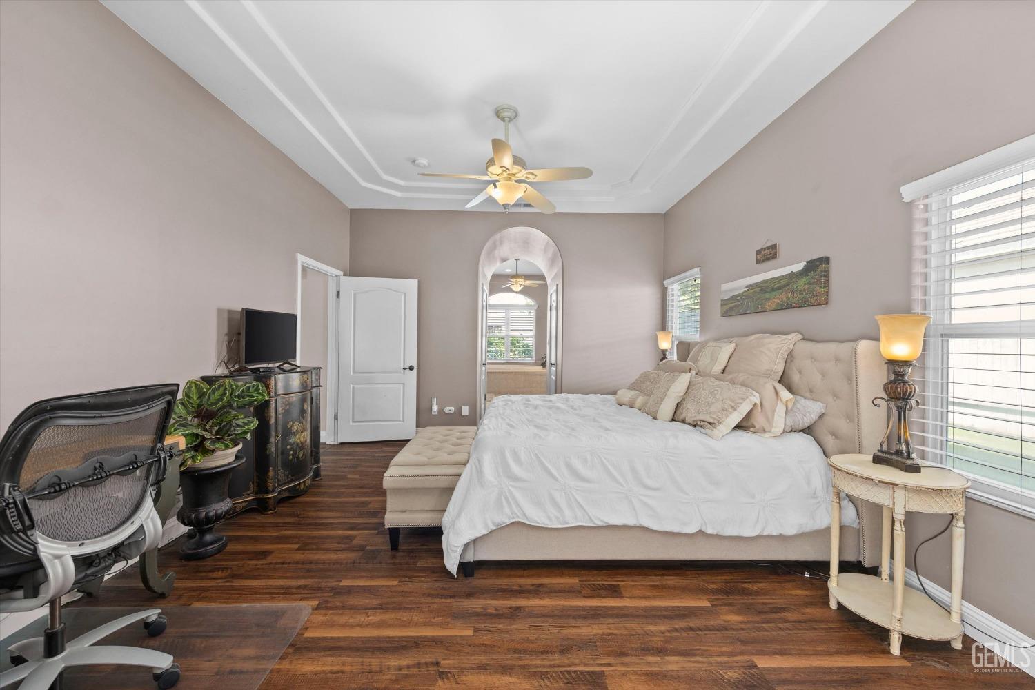 Undisclosed Address Bakersfield, CA 93314 - Photo 15 of 34 a spacious bedroom with a bed and a flat screen tv
