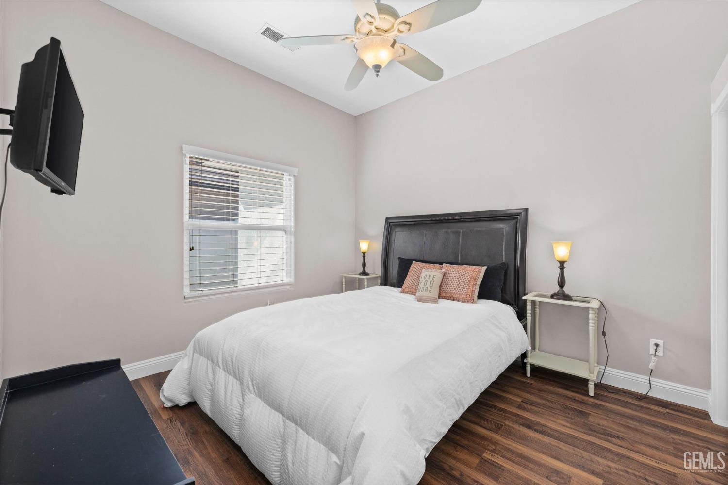 Undisclosed Address Bakersfield, CA 93314 - Photo 19 of 34 a bedroom with a bed and a chandelier