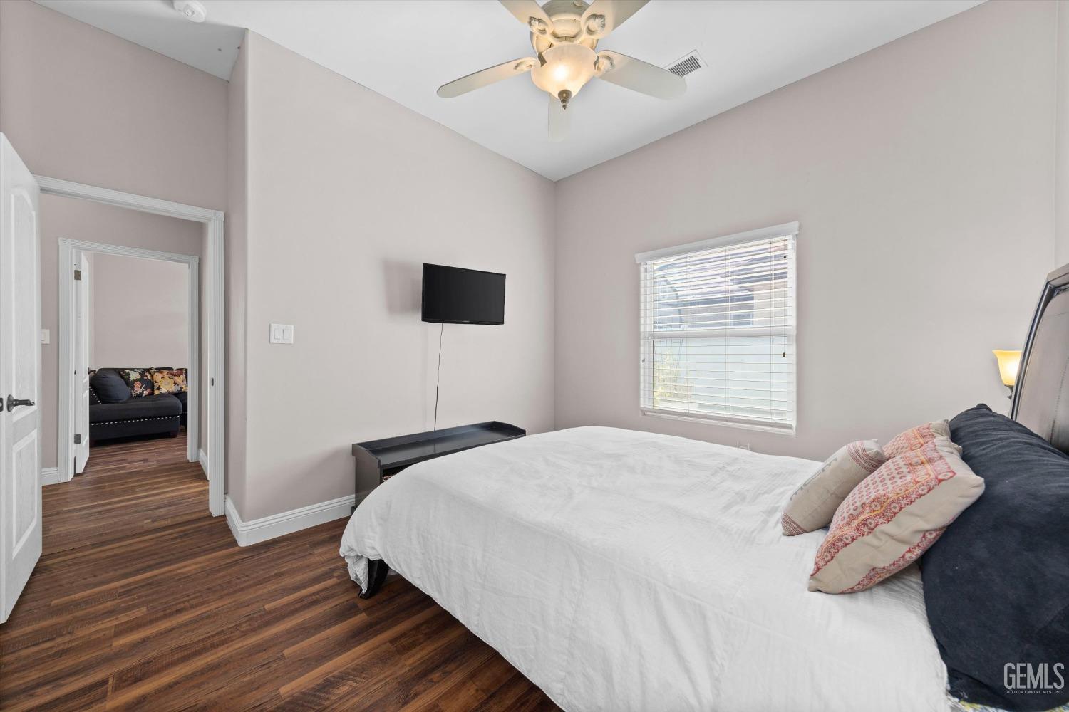 Undisclosed Address Bakersfield, CA 93314 - Photo 20 of 34 a bedroom with a bed and a chandelier