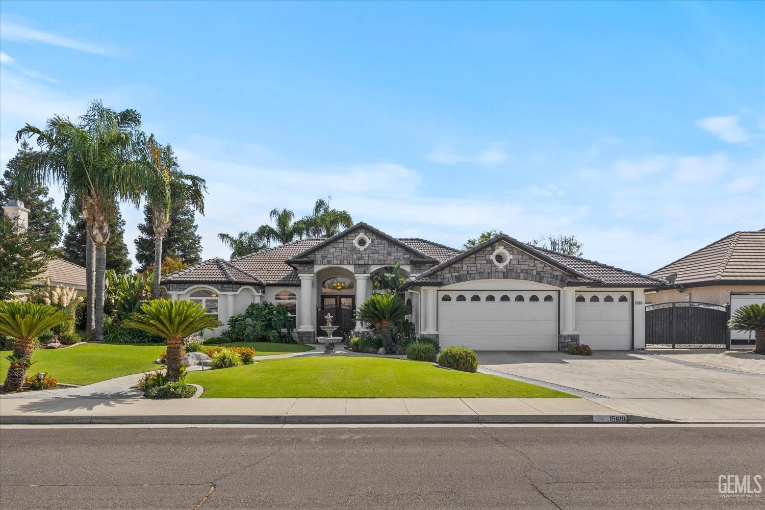 Undisclosed Address Bakersfield, CA 93314 - Photo 2 of 34 a front view of a house with a yard and garage