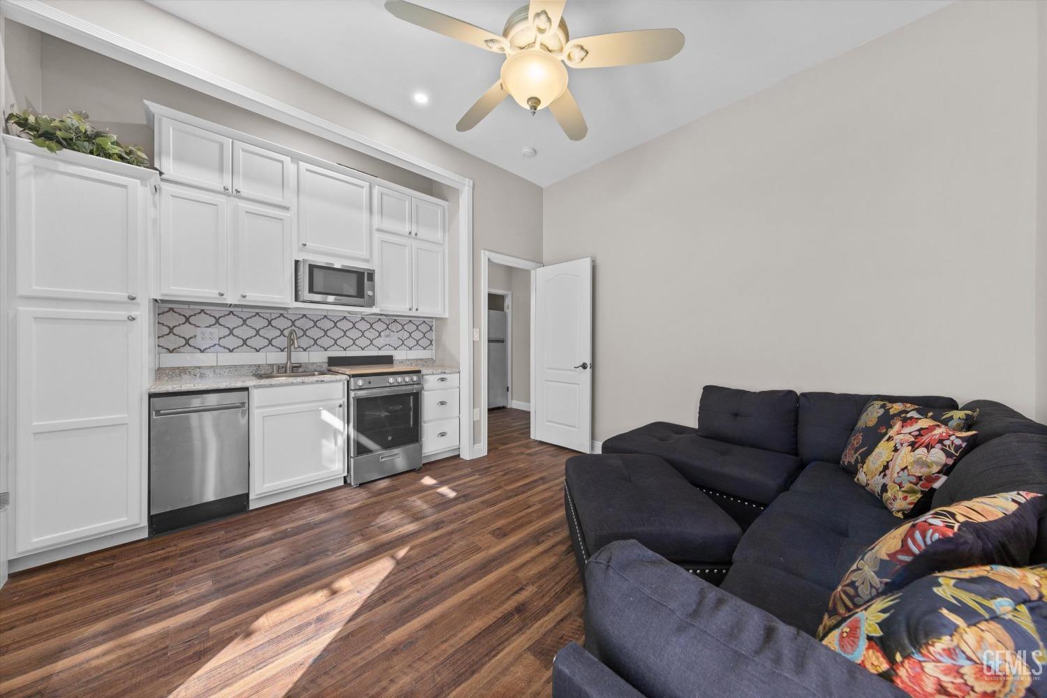 Undisclosed Address Bakersfield, CA 93314 - Photo 22 of 34 a living room with furniture fireplace and kitchen view