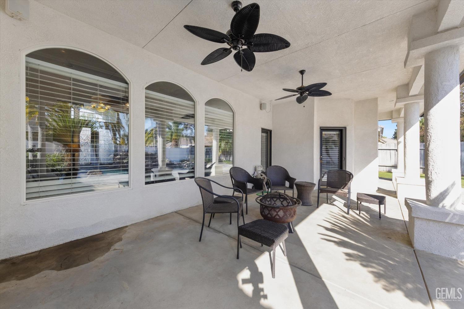 Undisclosed Address Bakersfield, CA 93314 - Photo 24 of 34 a living room with furniture a chandelier fan and a large window