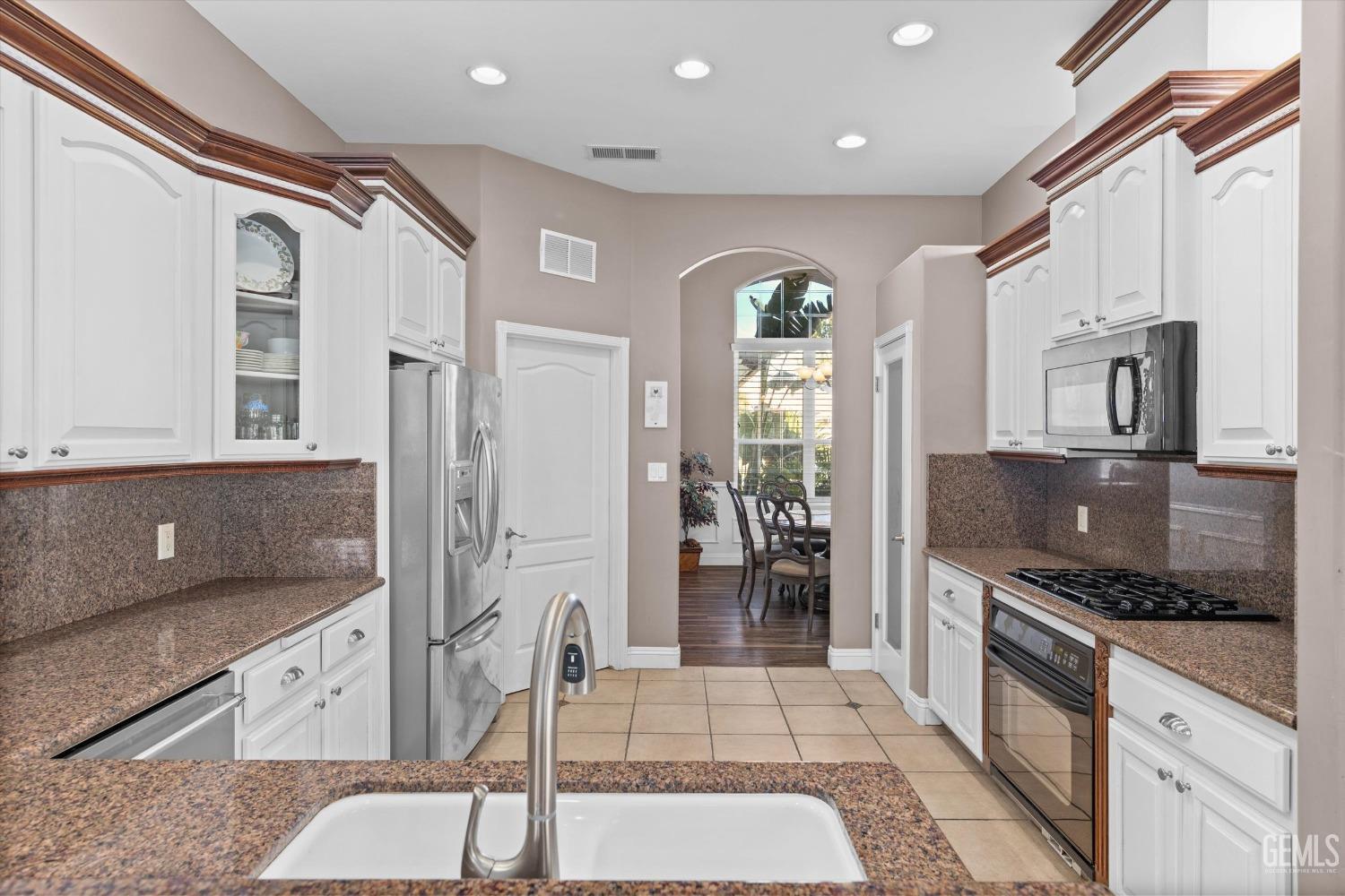 Undisclosed Address Bakersfield, CA 93314 - Photo 6 of 34 a kitchen with stainless steel appliances granite countertop a stove and a refrigerator