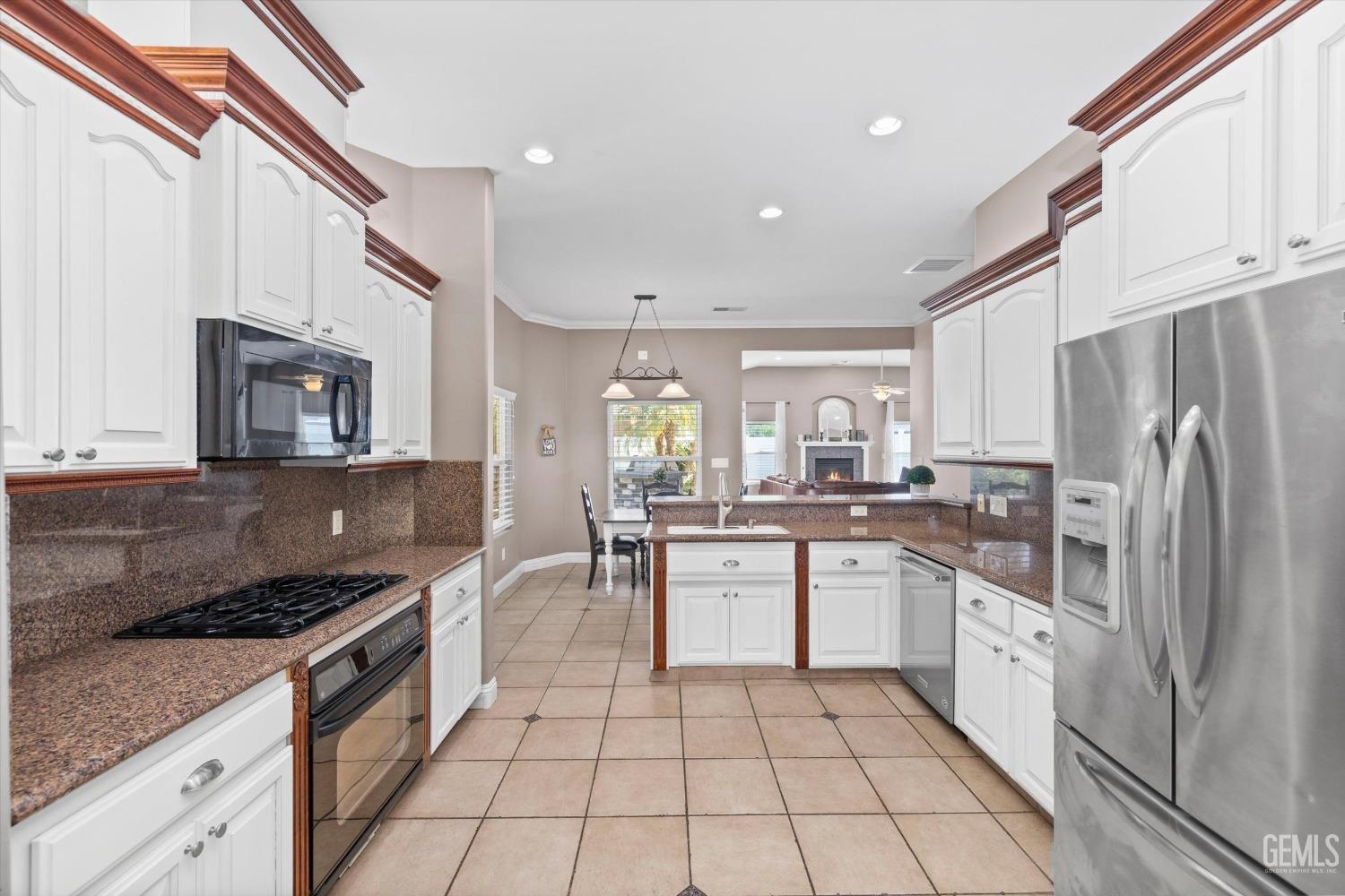 Undisclosed Address Bakersfield, CA 93314 - Photo 7 of 34 a kitchen with stainless steel appliances granite countertop a sink and a stove