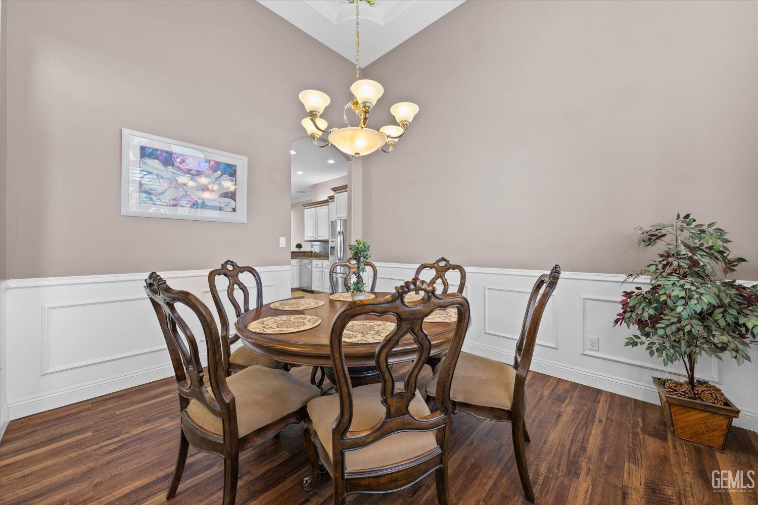 Undisclosed Address Bakersfield, CA 93314 - Photo 8 of 34 a dining room with furniture and wooden floor