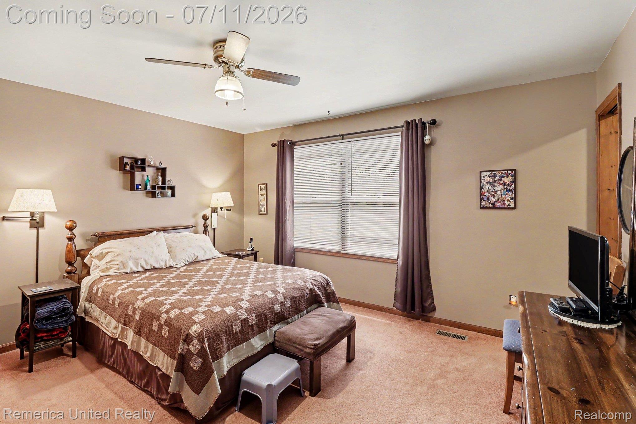 136 Endicott Howell, MI 48843 - Photo 16 of 28 Carpeted room featuring a ceiling fan with integrated lighting, a window with horizontal blinds, and a built-in wall shelf