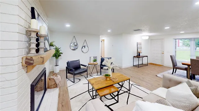 a living room with furniture a rug and white walls