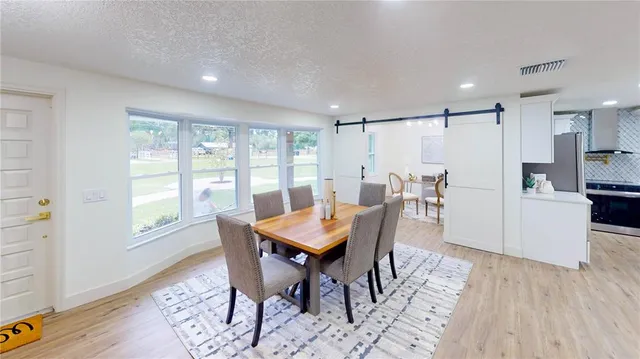 a view of a dining room with furniture window and wooden floor