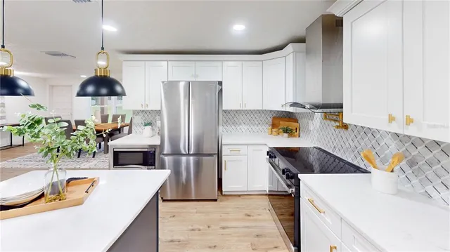 a kitchen with a sink a refrigerator and a stove