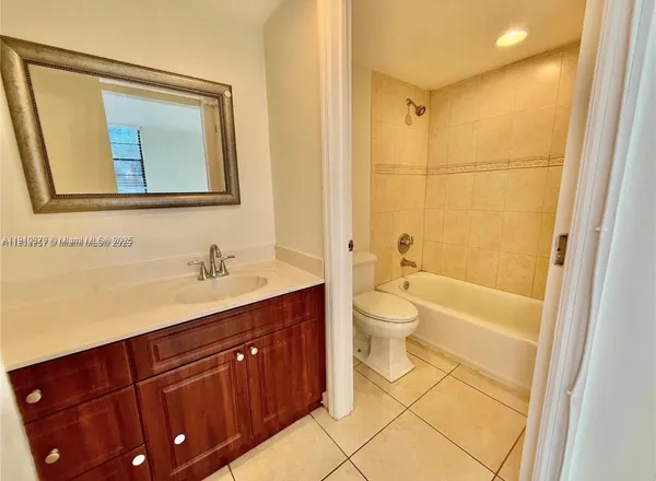 a bathroom with a granite countertop sink toilet a large mirror and shower