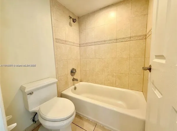 a white toilet sitting next to a bath tub