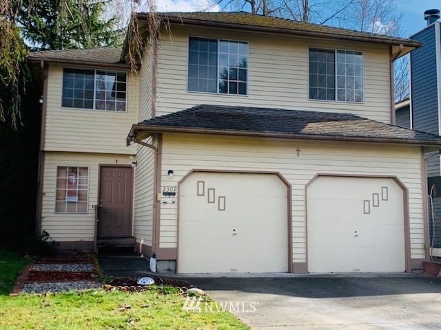 2309 Southeast 8th Drive Renton, WA 98057 - Photo 1 of 14 a front view of a house with a yard