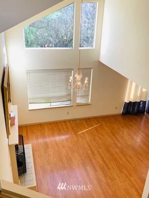 2309 Southeast 8th Drive Renton, WA 98057 - Photo 2 of 14 a view of an empty room with wooden floor and a window
