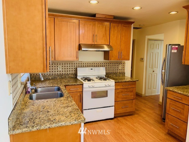 2309 Southeast 8th Drive Renton, WA 98057 - Photo 3 of 14 a kitchen with a stove and a refrigerator