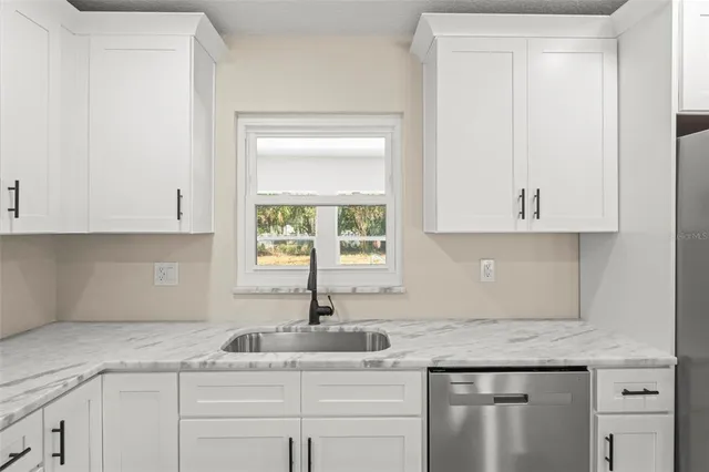 an empty room with wooden floor and fan