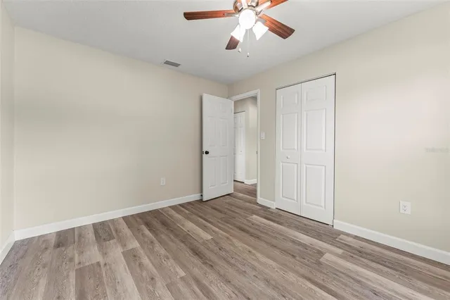a bathroom with a granite countertop toilet a sink and a mirror