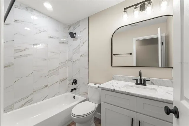 a bathroom with a granite countertop sink mirror and double
