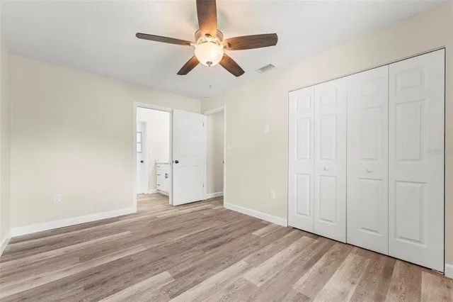 a bathroom with a granite countertop sink a mirror and shower